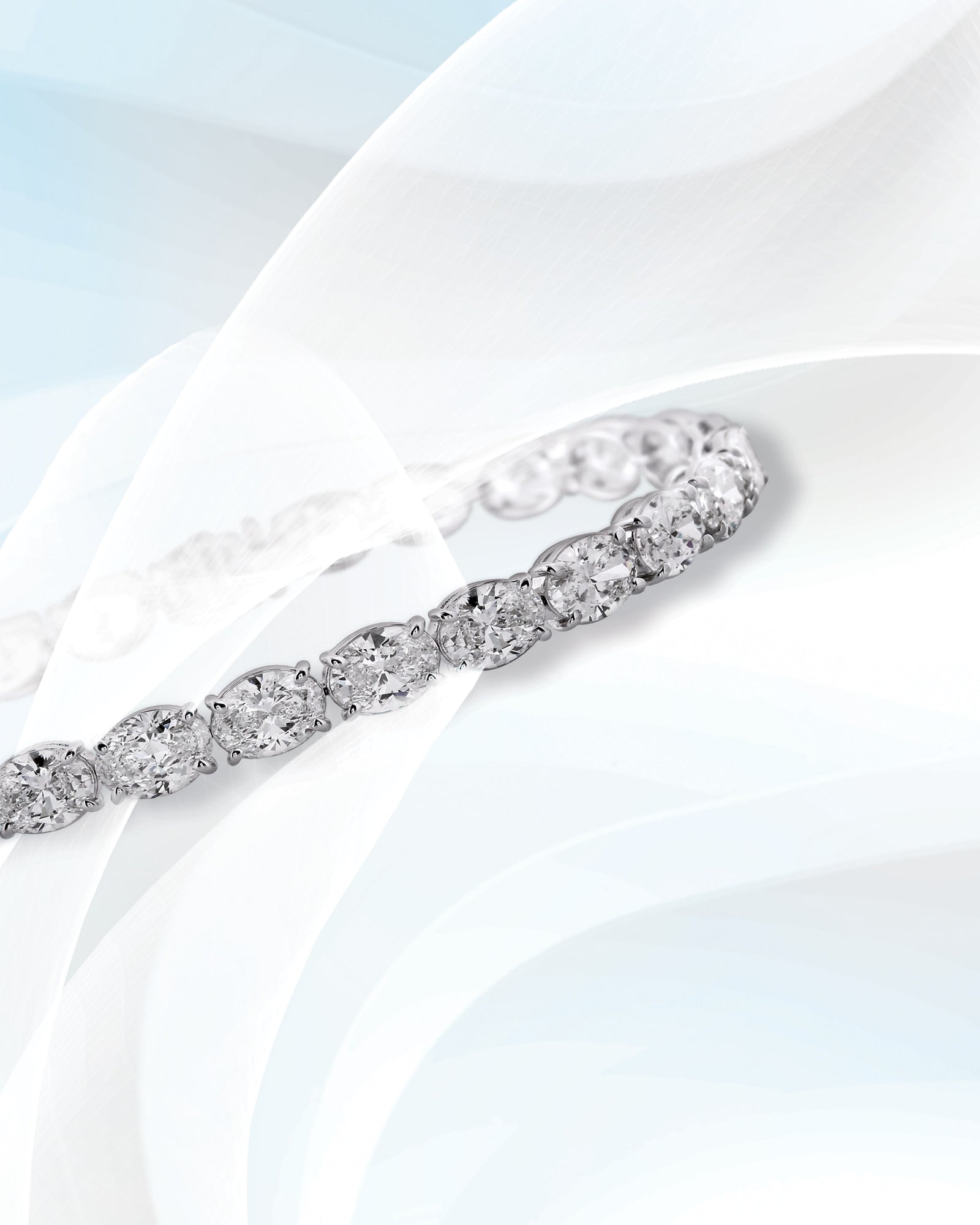 A diamond bracelet on pale silk.