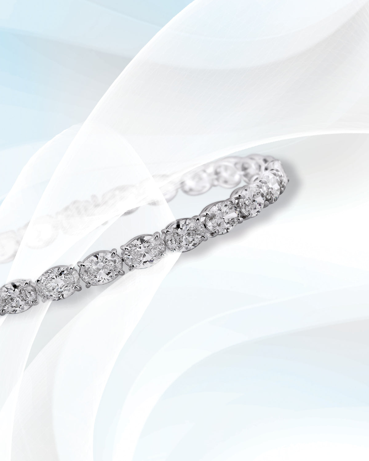 A diamond bracelet on pale silk.